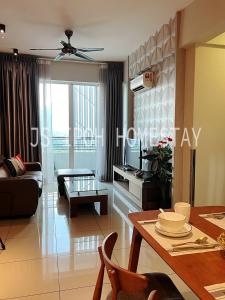 a living room with a couch and a table at JS Ipoh Homestay @ The Majestic Ipoh in Ipoh