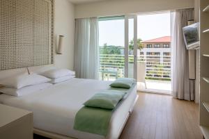 Postel nebo postele na pokoji v ubytování Versilia Lido | UNA Esperienze