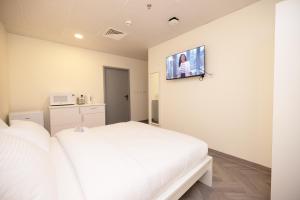 Postel nebo postele na pokoji v ubytování Riggae Tower Hotel