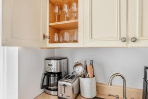 a kitchen counter with a coffee maker and a toaster at Back Bay Studio steps from Newbury T BOS-557 in Boston +8 photos