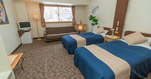 Postel nebo postele na pokoji v ubytování Shiga Grand Hotel
