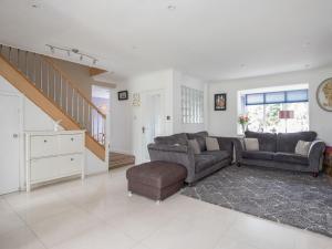 a living room with two couches and a staircase at Gorgeous Family Home Near River Thames-Old Windsor - Pass the Keys in Windsor