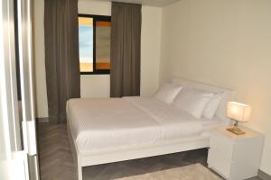 Postel nebo postele na pokoji v ubytování Riggae Tower Hotel