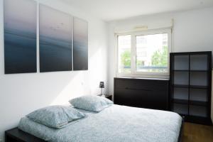 a bedroom with a bed and a window at EXIGEHOME-Beautiful apartment, 2 bedrooms 70m2 15 min from Paris in Rueil-Malmaison