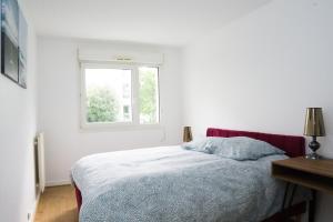 a white bedroom with a bed and a window at EXIGEHOME-Beautiful apartment, 2 bedrooms 70m2 15 min from Paris in Rueil-Malmaison