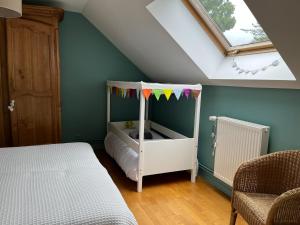 a childs bedroom with a crib in a attic at La Gitane in Saint-Valery-sur-Somme