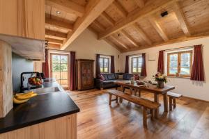 a kitchen and living room with wooden ceilings at Heimelei 