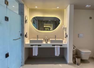 a bathroom with two sinks and a mirror at Casa Blue Resort in Marsa Alam City