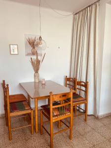 a dining room table with two chairs and a wooden table at Ferienwohnung in Vélez-Málaga, Málaga in Málaga +9 photos
