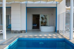 a house with a swimming pool next to a house at Casa Blue Resort in Marsa Alam City