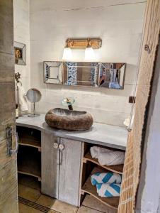 a bathroom with a counter with a sink in it at Chalet De Tahiti in Punaauia