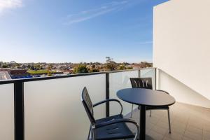 a table and chairs on a balcony with a view at Quest Werribee in Werribee