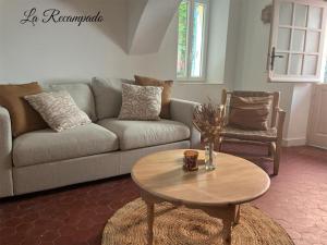 a living room with a couch and a coffee table at La Recampado in Bormes-les-Mimosas