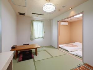 Postel nebo postele na pokoji v ubytování Sakura no Yakata Hotel