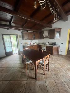 a kitchen with a table and chairs in a room at Casa Esterina in Garessio