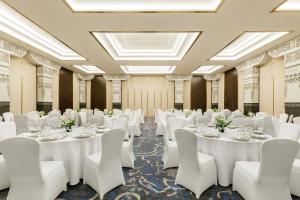 a banquet hall with white tables and white chairs at Dusit Princess Kathmandu in Kathmandu