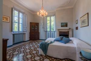 a bedroom with a bed and a chandelier at Villa Liberty in Osimo
