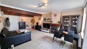 a living room with a couch and a table at Hotel Cardiff in Ostend