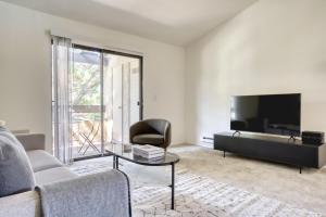 a living room with a couch and a tv at Mountain View 1BR w WD Pool Gym nr groceries SFO-1067 in Mountain View