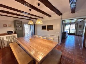 comedor con mesa de madera y sillas en Masía Casa Rullo, en Allepuz