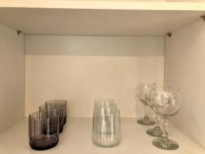 four empty wine glasses sitting on a shelf at Luxury flat with Sea & City view - Gym & Parking ( 93 ) - 9255745 in Beylikduzu
