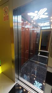 a elevator in a building with a glass door at Hotel Inka Pisac in Pisac