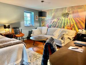 a living room with a couch and a table at Sydkustens at Pillehill in Skivarp