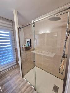 a bathroom with a glass shower with a sink at Appart refait à neuf 800m port de Sanary sur Mer in Sanary-sur-Mer