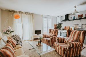 a living room with a couch and two chairs and a table at 1880 HAROs OLD TOWN HOUSE in Haro