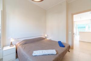 a bedroom with a bed with a blue towel on it at Asti Comfy Apartment - Private Parking! in Asti