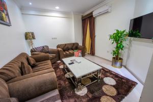 a living room with two couches and a table at Al Masem Luxury Hotel Suites 3 Al Ahsa in Al Hofuf