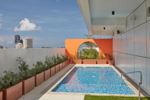 a swimming pool on the roof of a building at Belmont Hotel Mactan in Mactan