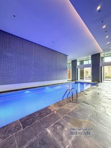 a large swimming pool in a building at La Casa By Arabian Nights - City View - Bespoke Design in Dubai