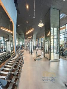 a gym with rows of exercise equipment in a building at La Casa By Arabian Nights - City View - Bespoke Design in Dubai