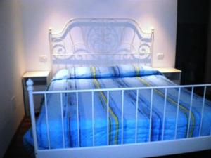 a bed with a blue comforter in a bedroom at Conero Ranch in Porto Recanati