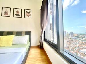 a room with a large window with a bed and a view at Tropicana 218 Macalister - Georgetown Family Homely 2BR Suite in George Town