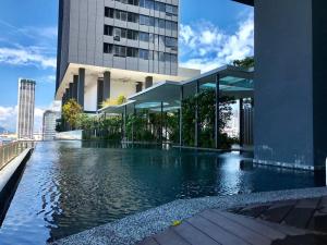 a swimming pool in front of a building at Tropicana 218 Macalister - Georgetown Family Homely 2BR Suite in George Town