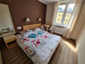 a bedroom with a large bed with flowers on it at Fantastic Waw - Z6 Room - 204A in Warsaw