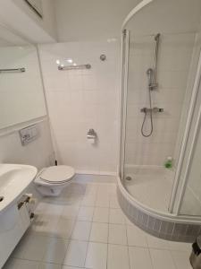 a white bathroom with a shower and a toilet at Fantastic Waw - Z6 Room - 204A in Warsaw