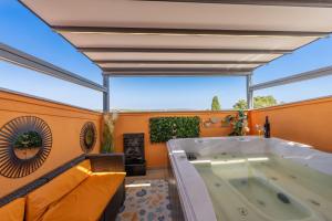 a hot tub in a room with a large window at Venus Holiday House with Pool in Banjole