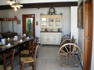 a dining room with a table and a clock on a wall at Conero Ranch in Porto Recanati