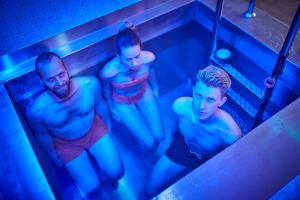 two men in a bath tub with blue lights at Hotel Saalbacher Hof in Saalbach-Hinterglemm