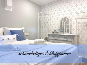 a bedroom with a bed and a dresser and a mirror at Customflats Erfurt - Tiefgarage - frisch renoviert in Erfurt