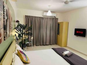 a hotel room with a bed and a window at Sage : Private Studio Room in Koregaon Park in Pune