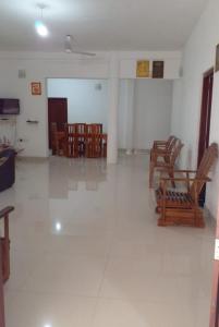 an empty room with chairs and tables in a room at Minsara Villa in Hikkaduwa