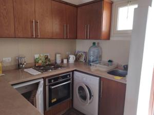 a kitchen with a washing machine and a sink at British style in Makadi Heights in Hurghada