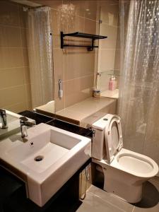 a white bathroom with a sink and a toilet at SUNWAY GRID Home Sweet Home 8 Pax in Kampong Pendas