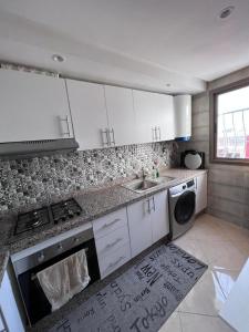 a kitchen with a sink and a stove top oven at Appartement la Ville Haute in Kenitra