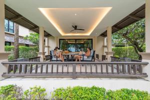 two women sitting on the front porch of a house at Layana Resort & Spa - Adult Only - SHA Extra Plus in Ko Lanta