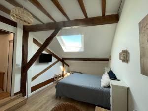 a bedroom with a bed in a room with wooden beams at LA CHOUETTE DU LAC MARION in Biarritz